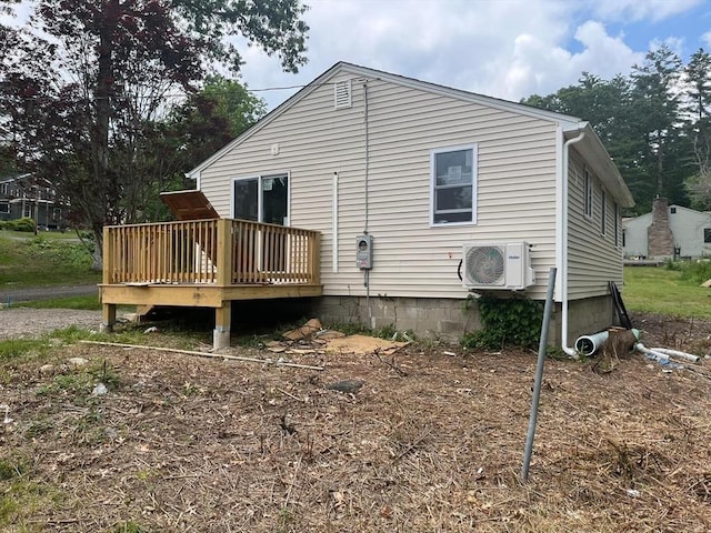 rear view of house with ac unit and a wooden deck