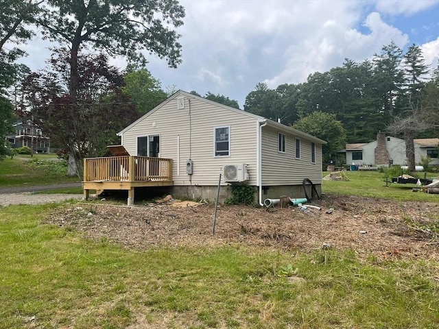 view of home's exterior with ac unit, a yard, and a wooden deck