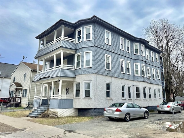 403 Orange St, Springfield, MA 01108 - view of front of house with stucco siding and a balcony