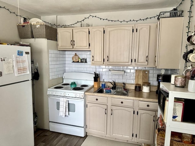 403 Orange St, Springfield, MA 01108 - kitchen featuring light countertops, a sink, dark wood-type flooring, white appliances, and tasteful backsplash