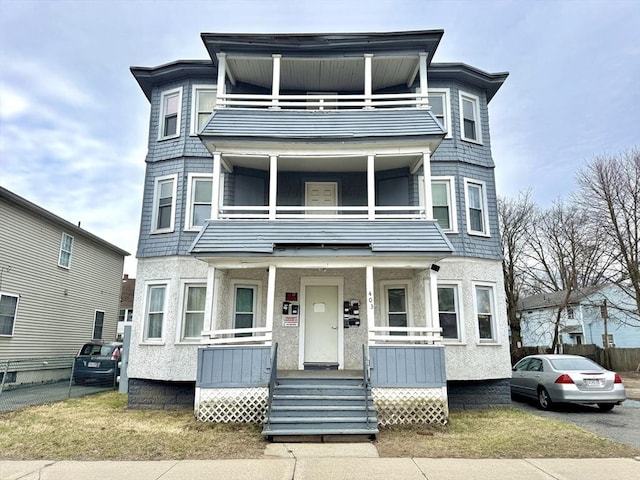 403 Orange St, Springfield, MA 01108 - victorian-style house with stucco siding, a balcony, and covered porch