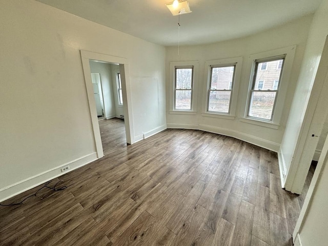 403 Orange St, Springfield, MA 01108 - empty room featuring baseboards, a healthy amount of sunlight, and dark wood-type flooring