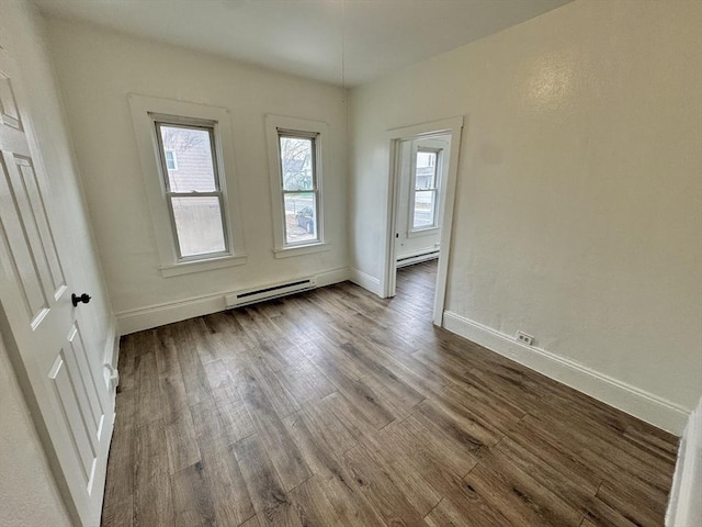 403 Orange St, Springfield, MA 01108 - spare room with baseboards, baseboard heating, and dark wood-style floors
