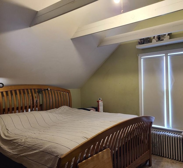 bedroom featuring lofted ceiling and radiator heating unit