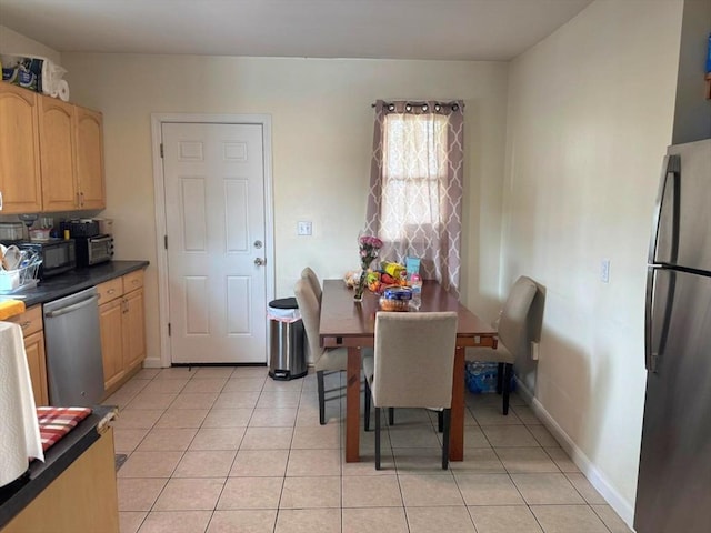 dining room with baseboards and light tile patterned flooring