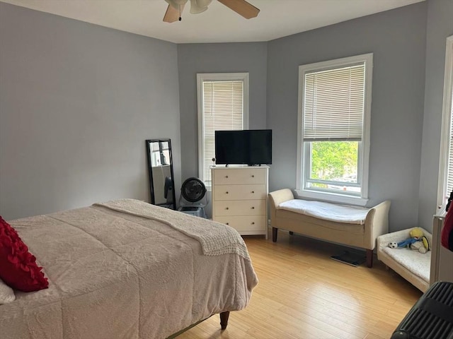bedroom with light wood finished floors and a ceiling fan