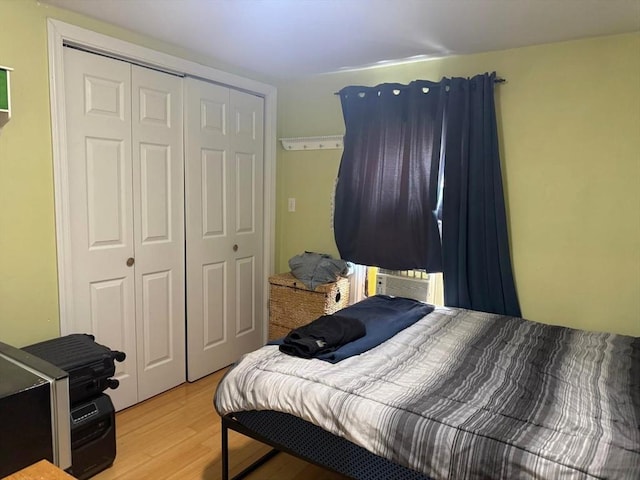 bedroom with light wood-style floors and a closet