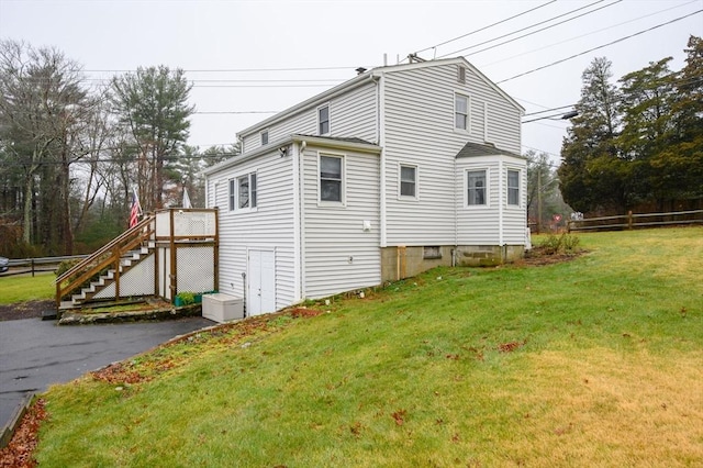 view of home's exterior featuring a lawn