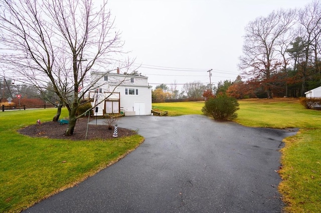 view of front facade with a garage and a front lawn