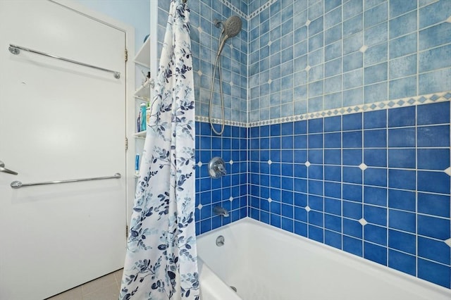 bathroom featuring tile patterned flooring and shower / bathtub combination with curtain