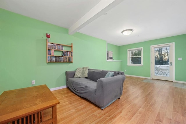 living room featuring beam ceiling and hardwood / wood-style floors