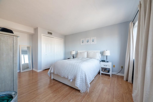 bedroom with a closet and light hardwood / wood-style flooring