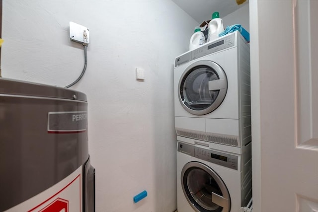 washroom featuring stacked washer and clothes dryer