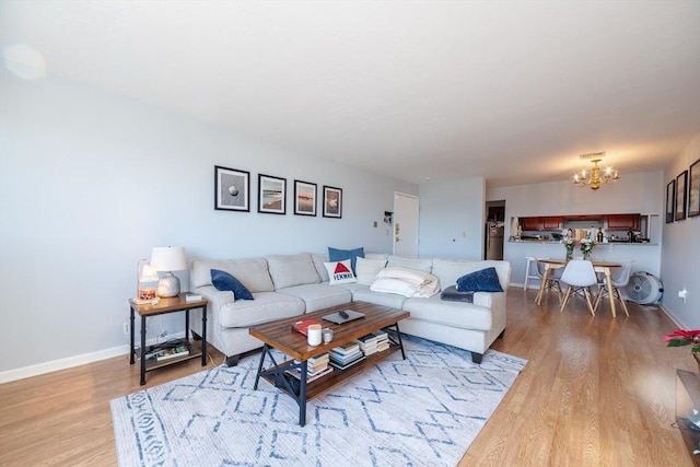 living room with a chandelier and light wood-type flooring