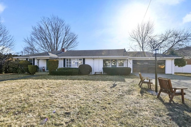 single story home featuring a garage and aphalt driveway