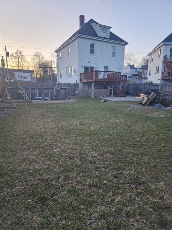 yard at dusk with a deck