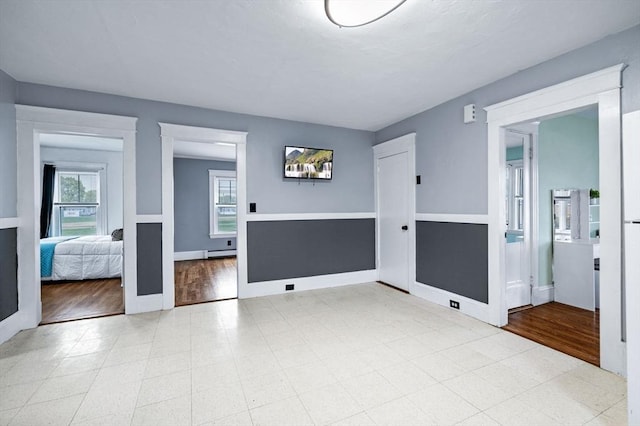interior space with a baseboard heating unit and baseboards