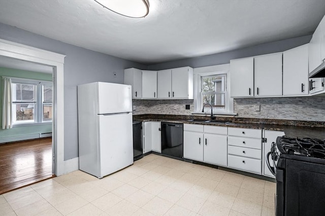 kitchen featuring tasteful backsplash, black appliances, a baseboard heating unit, and a sink