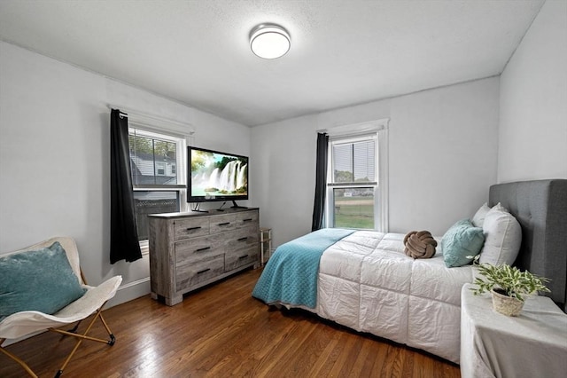 bedroom with dark wood finished floors