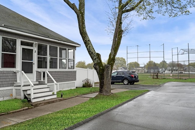 exterior space featuring a sunroom and fence