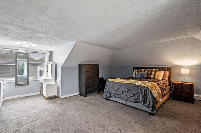 bedroom with lofted ceiling, a textured ceiling, carpet, and baseboards