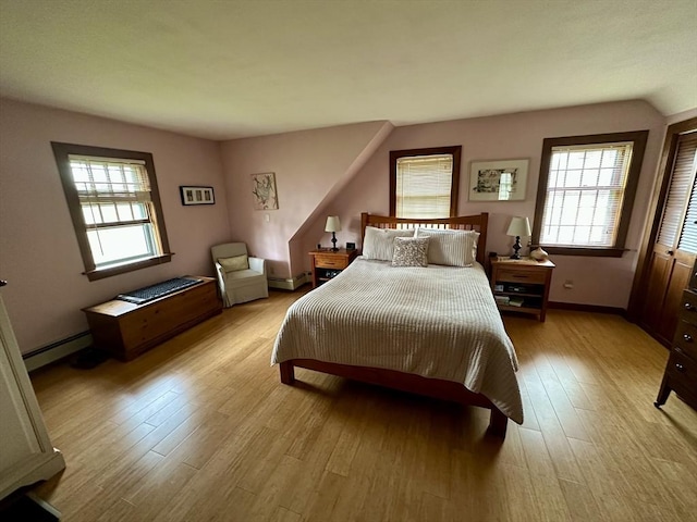 32 Machipscat Trl, West Tisbury, MA 02575 - bedroom with a baseboard heating unit, light wood-style floors, and baseboards
