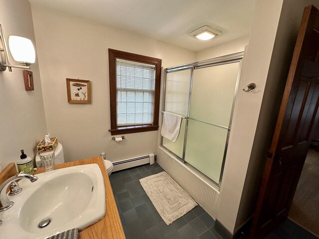 32 Machipscat Trl, West Tisbury, MA 02575 - full bathroom featuring a sink, a baseboard radiator, toilet, and bath / shower combo with glass door
