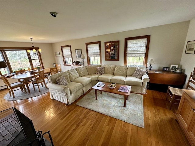 32 Machipscat Trl, West Tisbury, MA 02575 - living area featuring a chandelier, plenty of natural light, and light wood-style floors