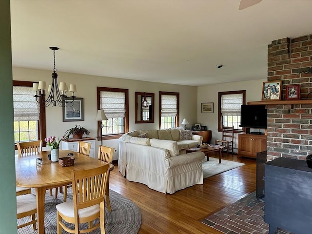 32 Machipscat Trl, West Tisbury, MA 02575 - dining area featuring an inviting chandelier, a healthy amount of sunlight, and dark wood-style floors