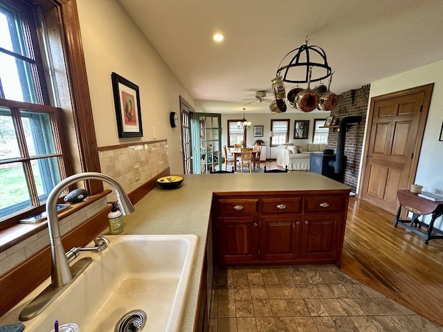 32 Machipscat Trl, West Tisbury, MA 02575 - kitchen with recessed lighting, a sink, a peninsula, a wood stove, and light countertops