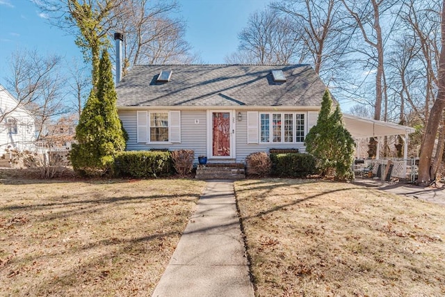 new england style home with a front yard and a shingled roof