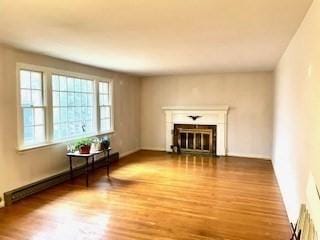 living room featuring hardwood / wood-style floors and baseboard heating