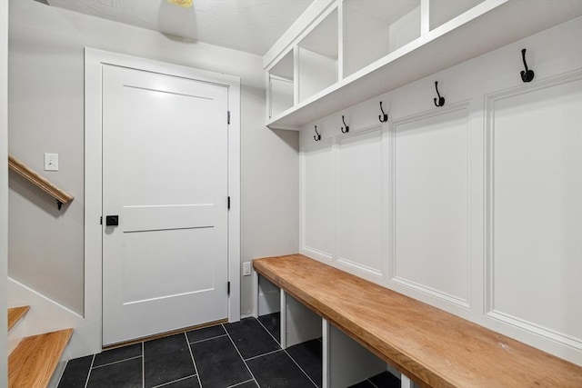 mudroom featuring dark tile patterned floors