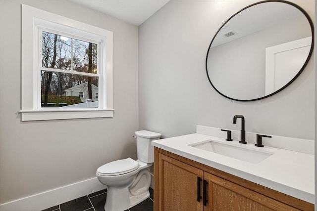 half bath featuring visible vents, baseboards, toilet, tile patterned flooring, and vanity