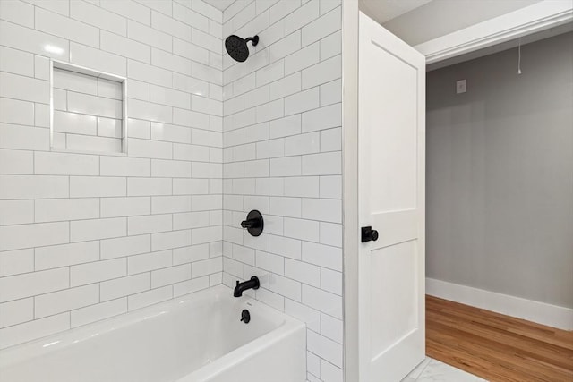 bathroom with baseboards and bathing tub / shower combination