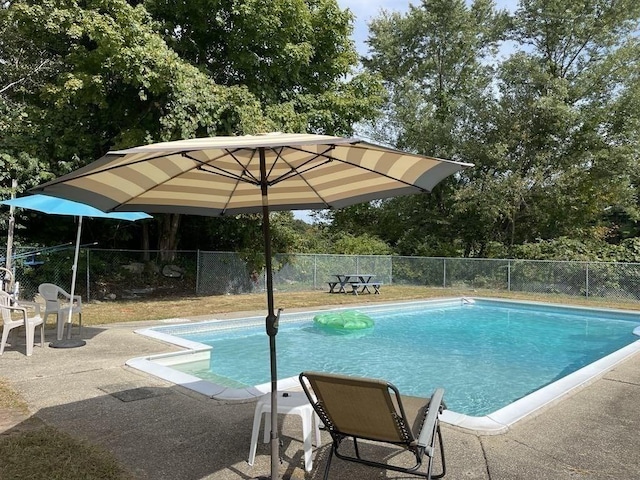 view of swimming pool with a fenced in pool, fence, and a patio