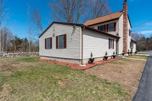 view of property exterior featuring a lawn and a chimney