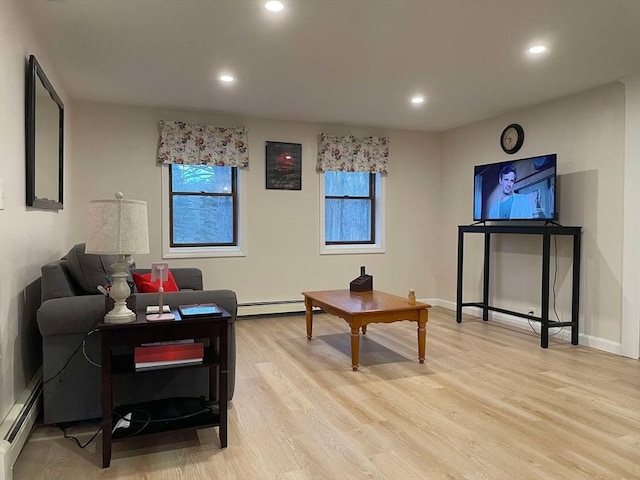 living room featuring recessed lighting, baseboards, light wood-type flooring, and a baseboard radiator