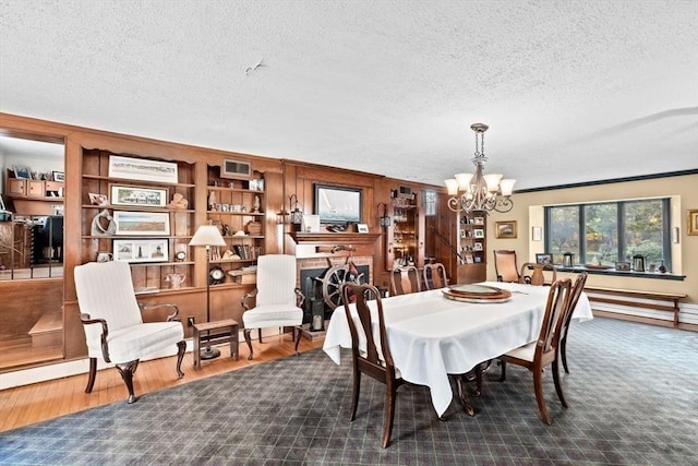 26 Mordecai Lincoln Rd, Scituate, MA 02066 - dining room with a chandelier, a textured ceiling, wood finished floors, and ornamental molding