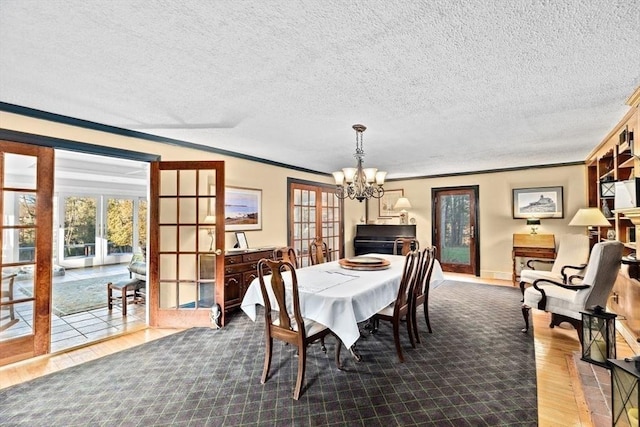 26 Mordecai Lincoln Rd, Scituate, MA 02066 - dining area featuring a chandelier, ornamental molding, wood finished floors, a textured ceiling, and french doors