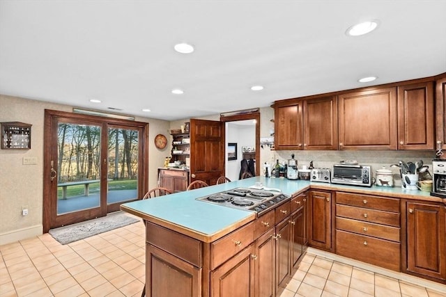 26 Mordecai Lincoln Rd, Scituate, MA 02066 - kitchen with stainless steel electric cooktop, light tile patterned flooring, recessed lighting, a peninsula, and brown cabinets