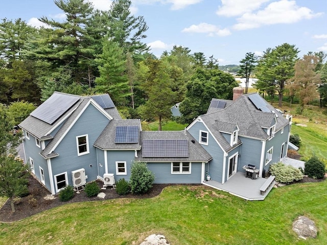 26 Mordecai Lincoln Rd, Scituate, MA 02066 - back of property featuring a yard, roof mounted solar panels, a patio, a cooling unit, and roof with shingles