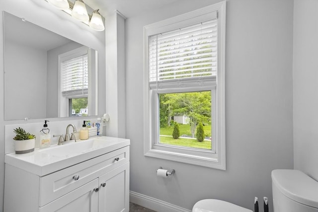 78 Conserve Ave, Westport, MA 02790 - bathroom with toilet, vanity, and baseboards
