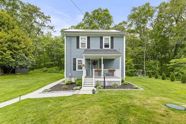 78 Conserve Ave, Westport, MA 02790 - view of front facade featuring a front lawn, roof mounted solar panels, a playground, and a porch