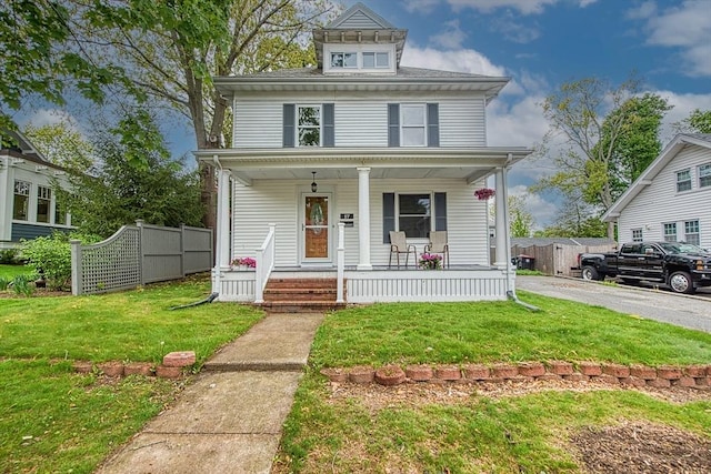 american foursquare style home featuring covered porch