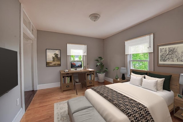 bedroom featuring baseboards and light wood-style flooring
