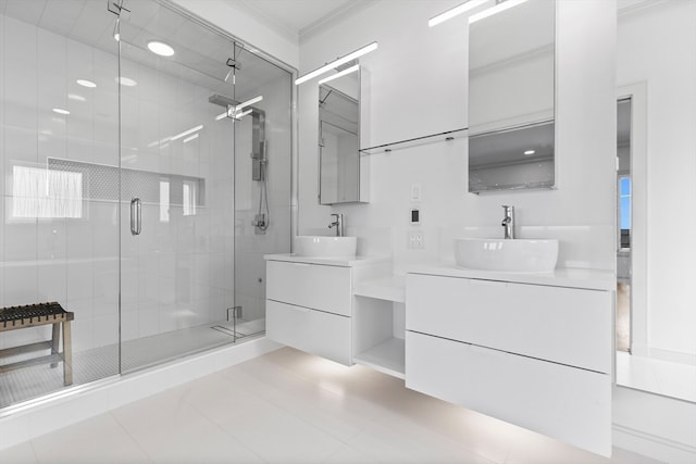 bathroom featuring tile patterned flooring, vanity, a shower with door, and crown molding