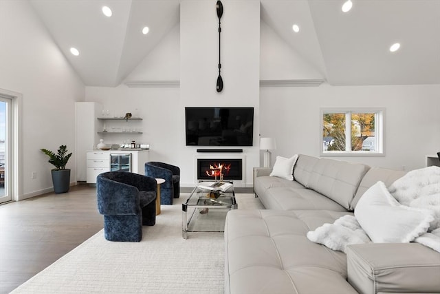 living room featuring light hardwood / wood-style flooring, high vaulted ceiling, and beverage cooler