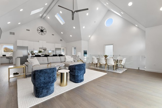 living room featuring ceiling fan, high vaulted ceiling, and light hardwood / wood-style floors