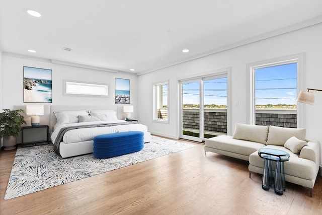 bedroom featuring access to outside, wood-type flooring, and ornamental molding